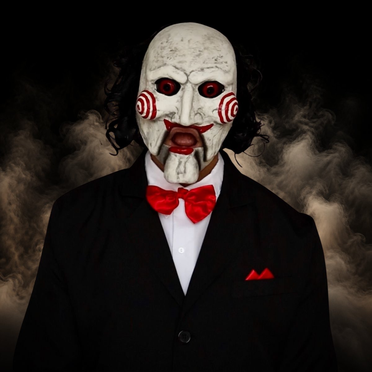 Puppet mask with a moving jaw worn with the black suit and white shirt