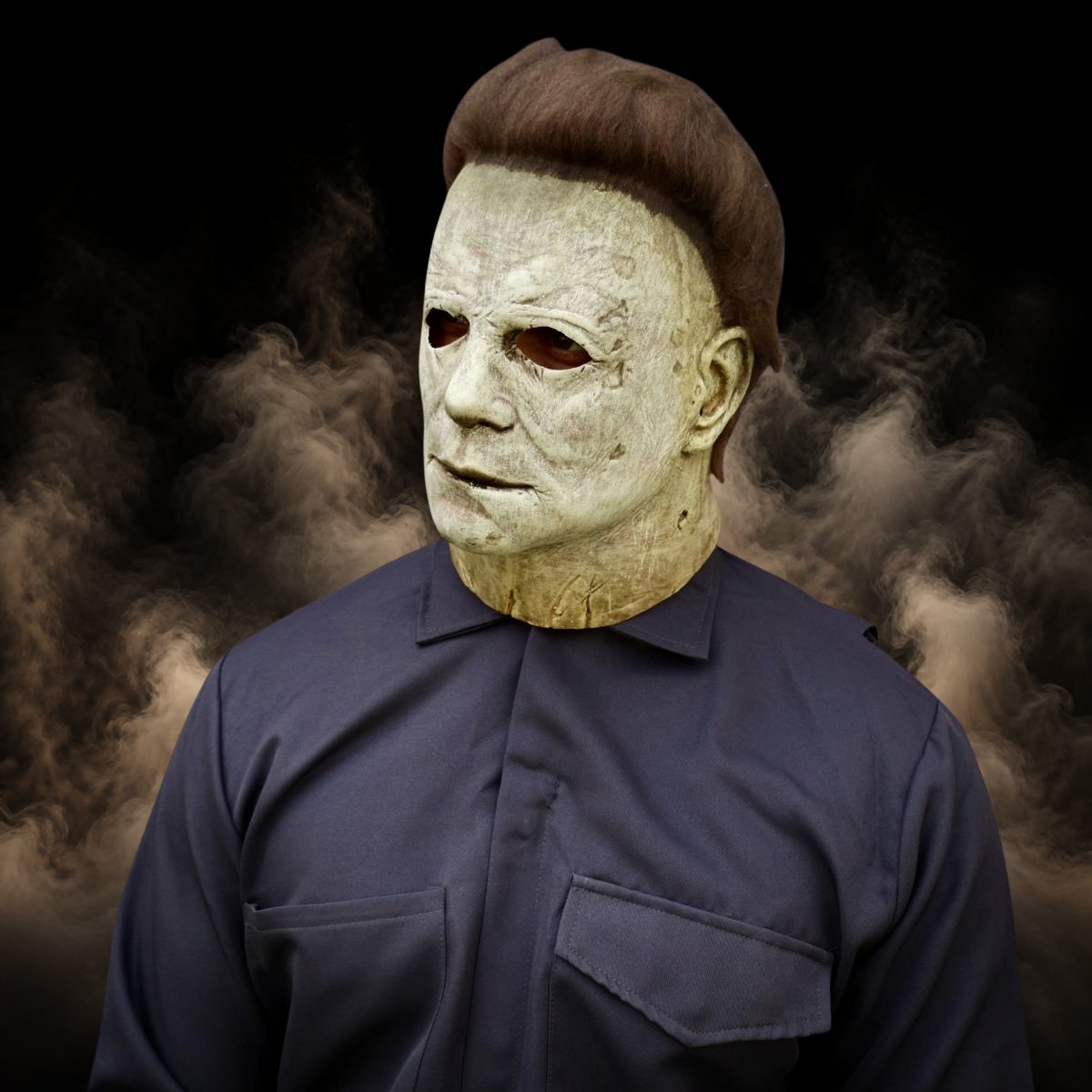 Pale slasher halloween mask worn with the coverall