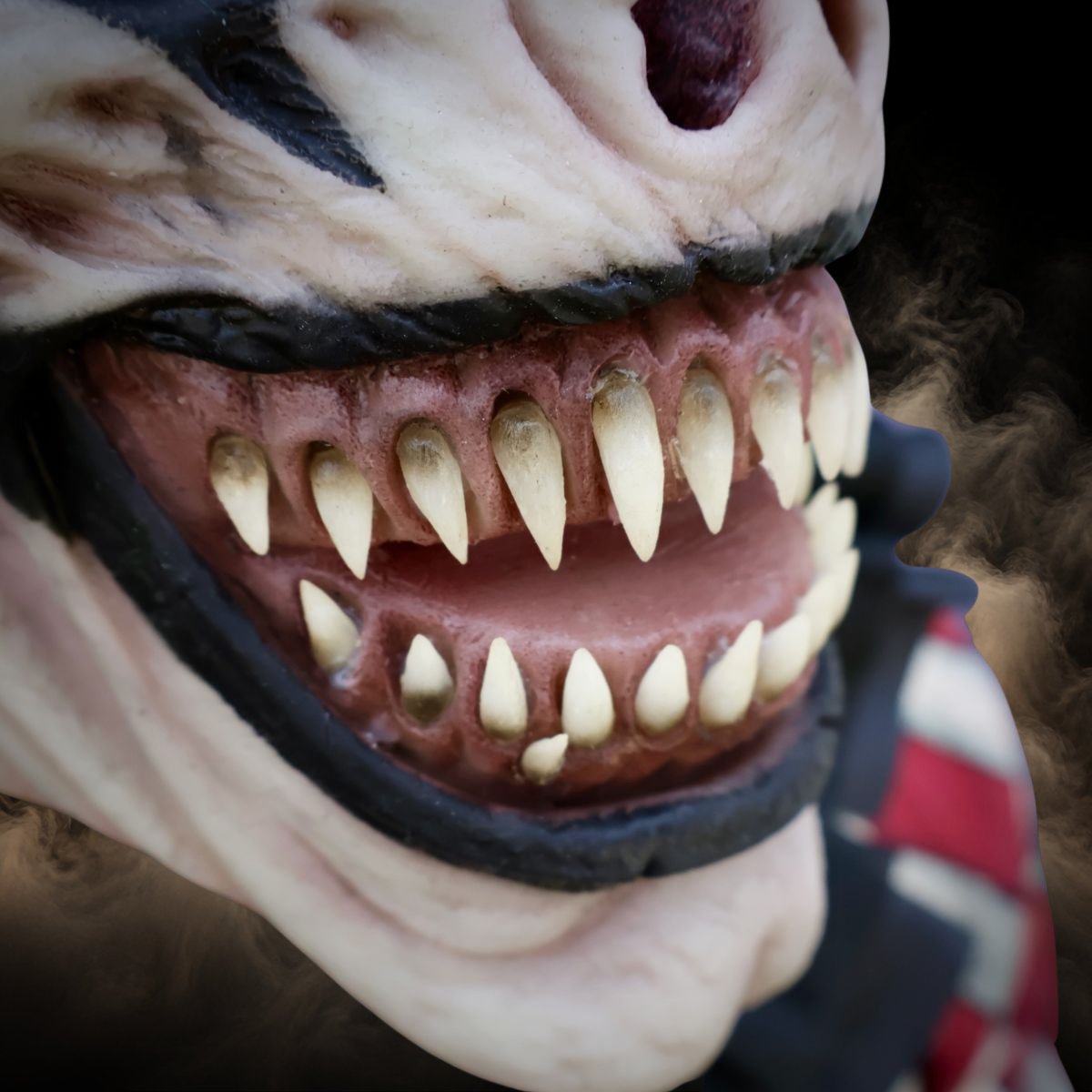 Close up of the painted teeth and lips on a jester clown mask